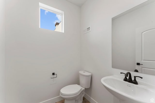 6134 S Kelly Ln, St George, UT 84790 - half bath featuring a sink, baseboards, and toilet