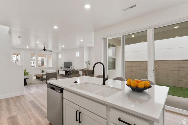 6134 S Kelly Ln, St George, UT 84790 - kitchen featuring dishwasher, a sink, open floor plan, white cabinets, and light wood-style floors