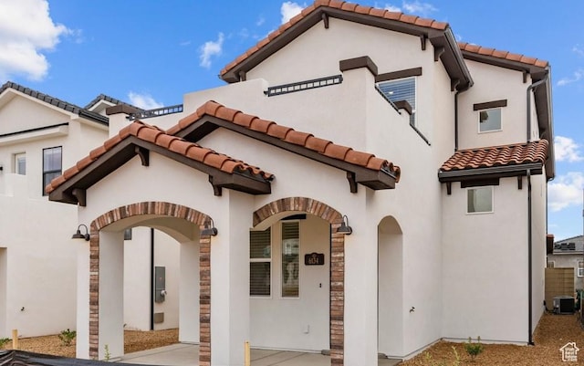 6134 S Kelly Ln, St George, UT 84790 - view of front of property with a tiled roof, central AC, stucco siding, and stone siding