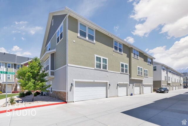 671 E 330 N, Vineyard, UT 84059 - view of property featuring a residential view, an attached garage, and driveway