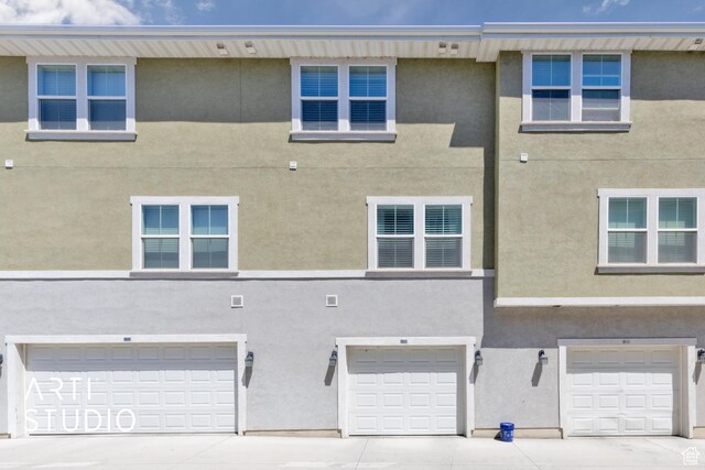 671 E 330 N, Vineyard, UT 84059 - rear view of property with an attached garage, stucco siding, and driveway