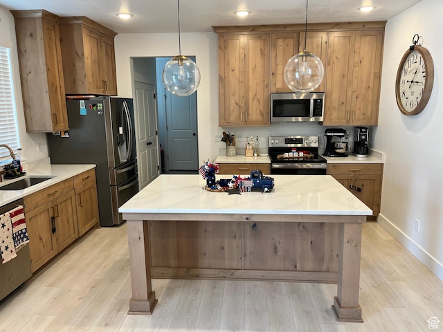3198 N 3475 W, Plain City, UT 84404 - kitchen featuring appliances with stainless steel finishes, a sink, light wood-type flooring, decorative light fixtures, and recessed lighting