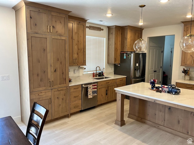 3198 N 3475 W, Plain City, UT 84404 - kitchen featuring appliances with stainless steel finishes, a sink, light countertops, hanging light fixtures, and recessed lighting