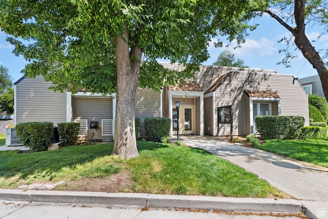 4614 S Quail Park Dr E Unit A, Millcreek, UT 84117 - view of front of property with driveway, a front lawn, and a carport