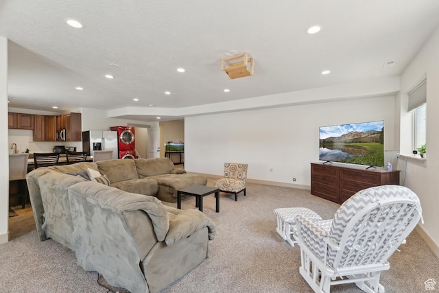 261 W 1200 S, Lehi, UT 84043 - living area featuring stacked washer and clothes dryer, recessed lighting, light colored carpet, and baseboards