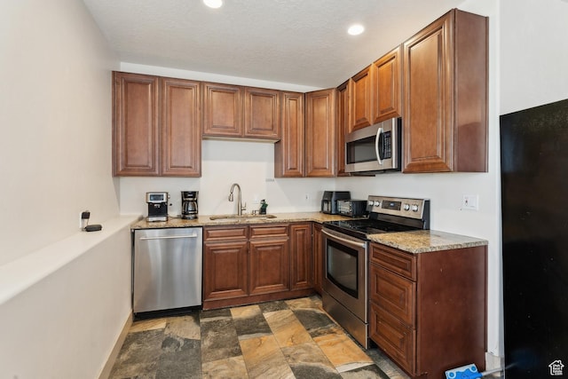 261 W 1200 S, Lehi, UT 84043 - kitchen featuring appliances with stainless steel finishes, a sink, stone finish floors, light stone countertops, and recessed lighting