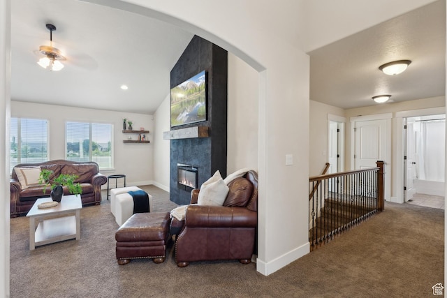 261 W 1200 S, Lehi, UT 84043 - carpeted living room with a tiled fireplace, vaulted ceiling, ceiling fan, baseboards, and arched walkways
