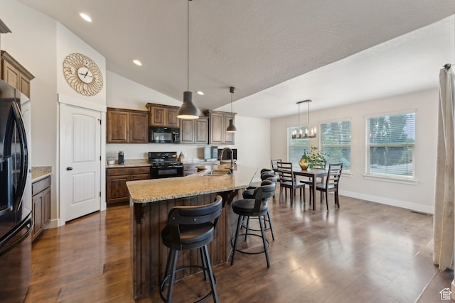 261 W 1200 S, Lehi, UT 84043 - kitchen featuring black appliances, a sink, a breakfast bar area, lofted ceiling, and recessed lighting