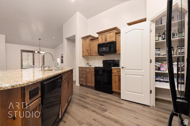 3504 E 3140 S, St George, UT 84790 - kitchen with black appliances, a sink, light wood-type flooring, light stone counters, and brown cabinets