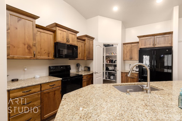 3504 E 3140 S, St George, UT 84790 - kitchen featuring black appliances, a sink, light stone countertops, brown cabinets, and vaulted ceiling