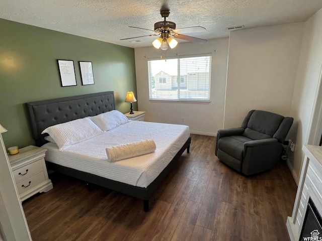 1305 S 1410 E, Provo, UT 84606 - bedroom with dark wood-type flooring, a textured ceiling, a ceiling fan, and baseboards