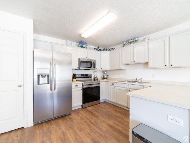 1305 S 1410 E, Provo, UT 84606 - kitchen featuring stainless steel appliances, a sink, a textured ceiling, white cabinetry, and dark wood finished floors