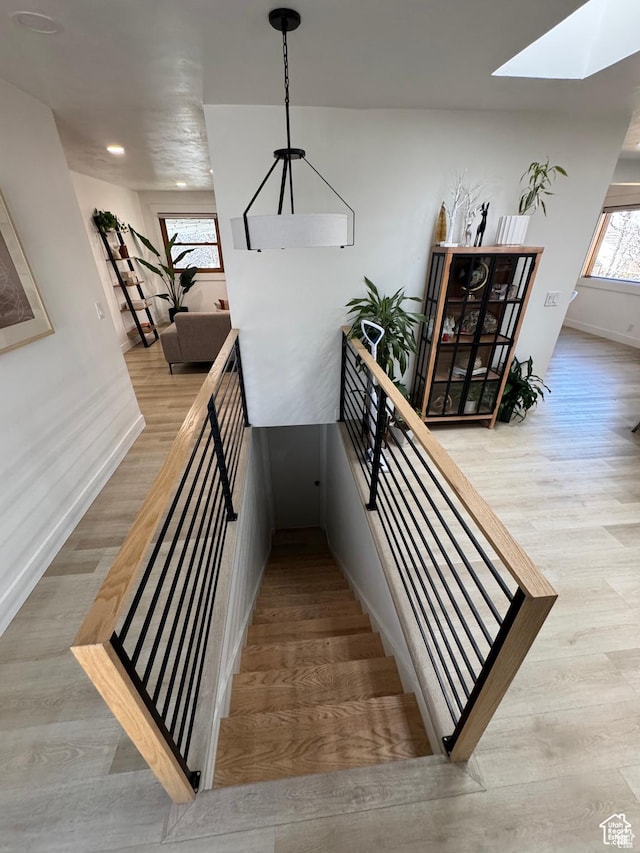 4288 S Shirley Ln, Holladay, UT 84124 - staircase featuring a skylight, wood finished floors, baseboards, and recessed lighting
