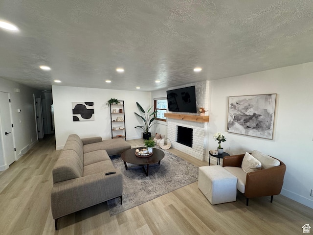 4288 S Shirley Ln, Holladay, UT 84124 - living room with wood finished floors, recessed lighting, a textured ceiling, baseboards, and a fireplace