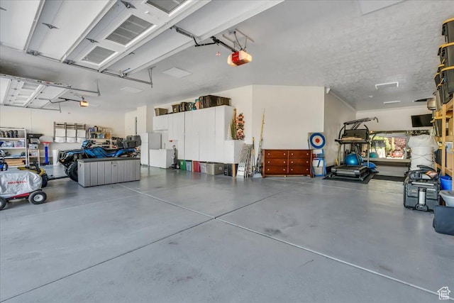 10605 S Willow Valley Rd W, South Jordan, UT 84095 - garage featuring a garage door opener and freestanding refrigerator