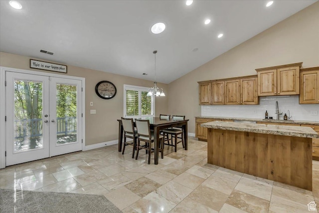 10605 S Willow Valley Rd W, South Jordan, UT 84095 - kitchen with a sink, a center island, tasteful backsplash, recessed lighting, and baseboards