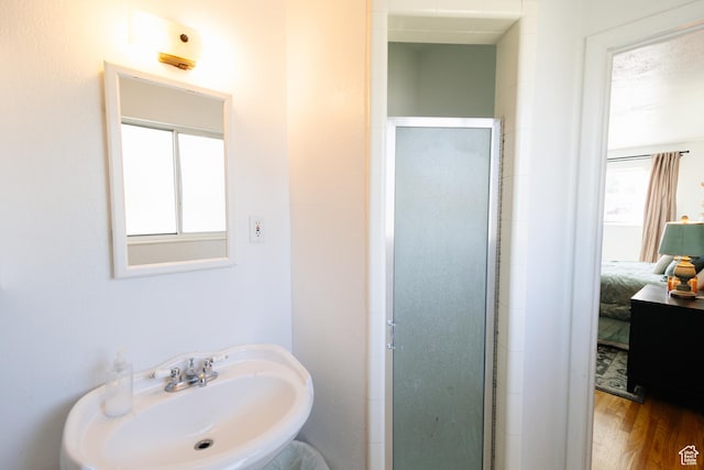 374 W Melba Dr S, Tooele, UT 84074 - ensuite bathroom with a sink, a shower stall, and wood finished floors