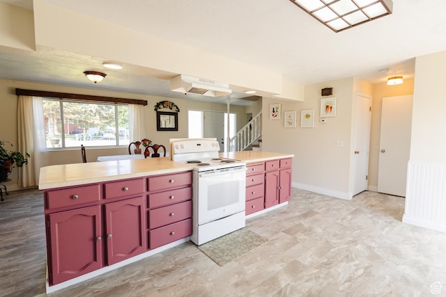 374 W Melba Dr S, Tooele, UT 84074 - kitchen featuring white electric stove, red cabinetry, under cabinet range hood, and light countertops