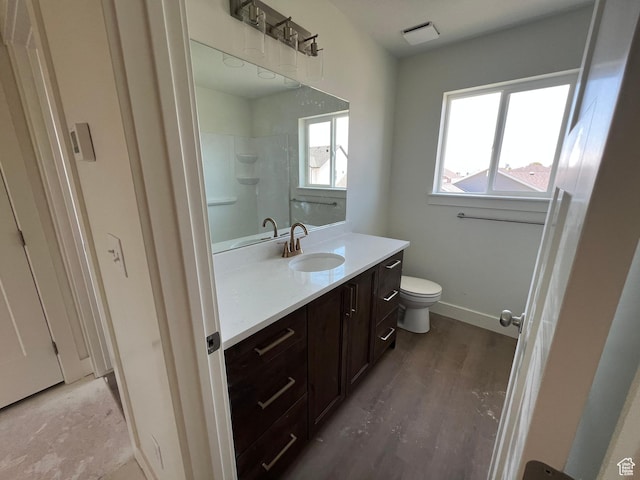 1154 E 1150 S, Garland, UT 84312 - full bathroom featuring vanity, toilet, a shower, and wood finished floors