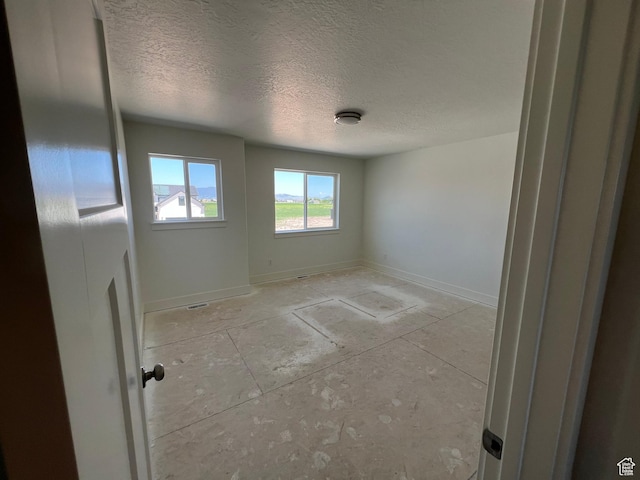 1154 E 1150 S, Garland, UT 84312 - empty room featuring a textured ceiling and baseboards