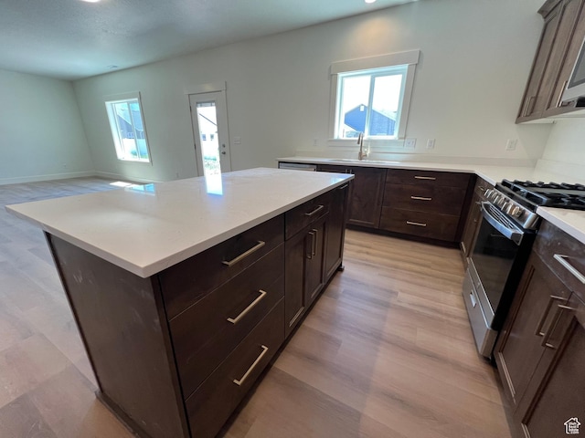 1154 E 1150 S, Garland, UT 84312 - kitchen featuring a sink, appliances with stainless steel finishes, light countertops, light wood-type flooring, and dark brown cabinetry
