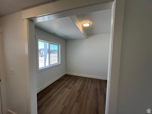 1154 E 1150 S, Garland, UT 84312 - empty room with dark wood finished floors, baseboards, and a textured ceiling