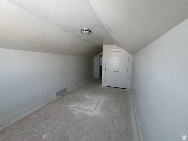 1154 E 1150 S, Garland, UT 84312 - bonus room featuring a textured ceiling, vaulted ceiling, and baseboards