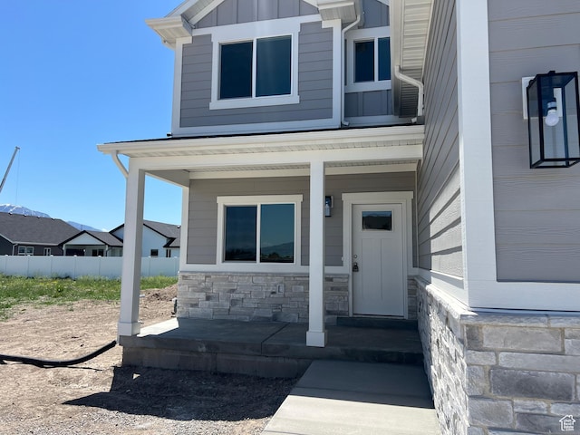1154 E 1150 S, Garland, UT 84312 - doorway to property with a porch, stone siding, and board and batten siding