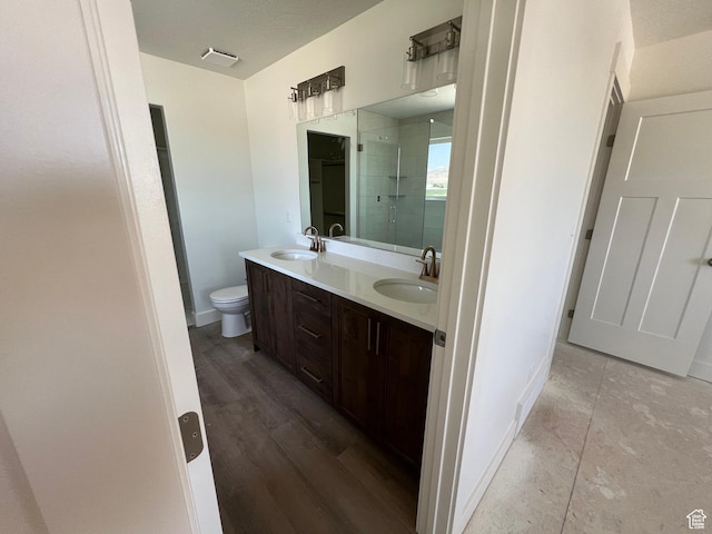 1154 E 1150 S, Garland, UT 84312 - full bath featuring double vanity, a stall shower, toilet, baseboards, and wood finished floors