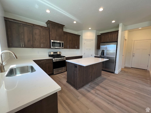 1154 E 1150 S, Garland, UT 84312 - kitchen featuring appliances with stainless steel finishes, a sink, a kitchen island, dark brown cabinets, and recessed lighting