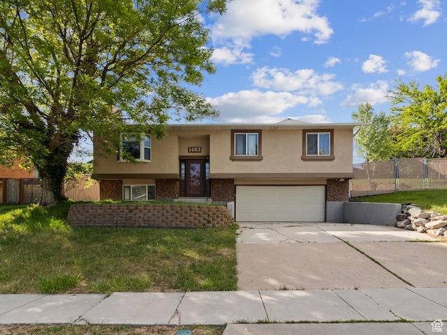 1463 Kays Creek Dr St, Layton, UT 84040 - bi-level home featuring stucco siding, driveway, a garage, and brick siding