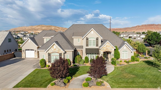 2931 S Carriage Ln, Washington, UT 84780 - french country inspired facade featuring stone siding, stucco siding, a mountain view, concrete driveway, and a front yard
