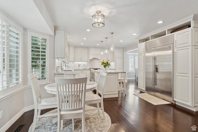12214 S Hidden Valley Rd, Sandy, UT 84092 - dining space featuring healthy amount of natural light, dark wood-type flooring, baseboards, a chandelier, and recessed lighting
