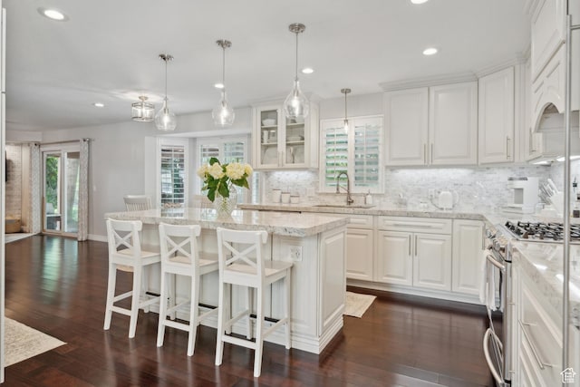 12214 S Hidden Valley Rd, Sandy, UT 84092 - kitchen featuring a sink, stainless steel gas stove, tasteful backsplash, recessed lighting, and white cabinets