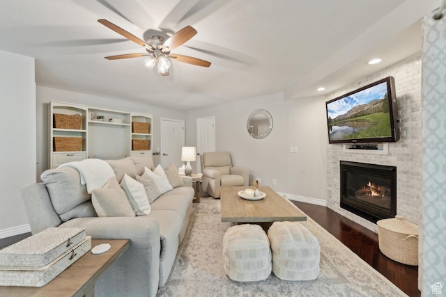 12214 S Hidden Valley Rd, Sandy, UT 84092 - living area with wood finished floors, baseboards, a ceiling fan, a brick fireplace, and recessed lighting