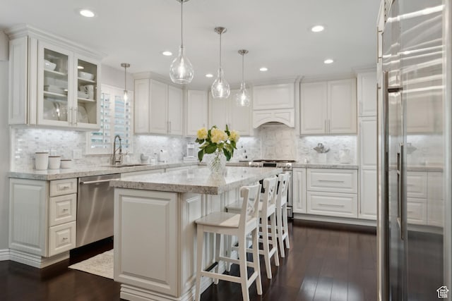 12214 S Hidden Valley Rd, Sandy, UT 84092 - kitchen featuring appliances with stainless steel finishes, a sink, white cabinetry, a center island, and recessed lighting
