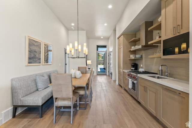 6312 Double Deer Loop, Park City, UT 84098 - kitchen featuring a sink, premium stove, open shelves, light wood finished floors, and backsplash