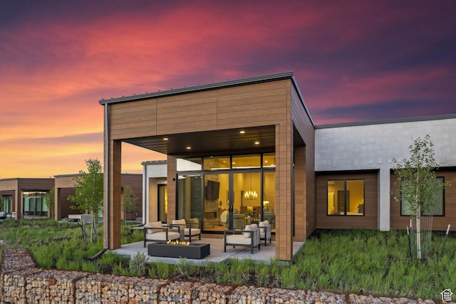 6312 Double Deer Loop, Park City, UT 84098 - back of house at dusk with an outdoor hangout area and a patio