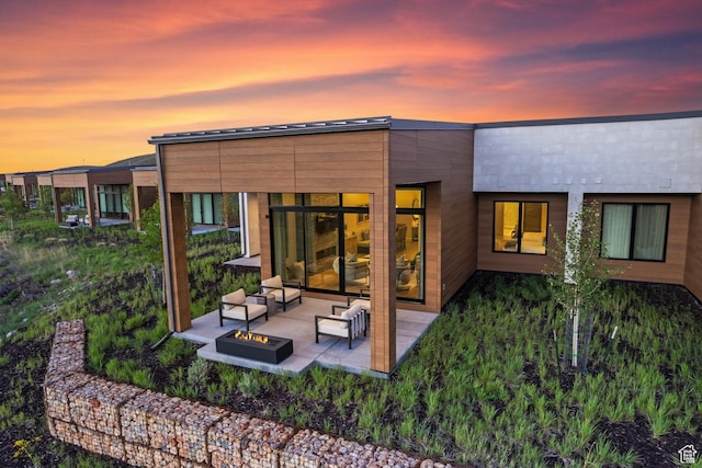 6312 Double Deer Loop, Park City, UT 84098 - back of house at dusk featuring a patio area and an outdoor living space with a fire pit