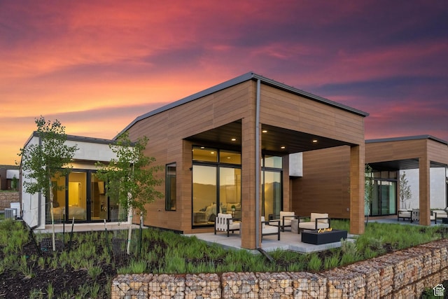 6312 Double Deer Loop, Park City, UT 84098 - back of property at dusk featuring a patio and an outdoor hangout area