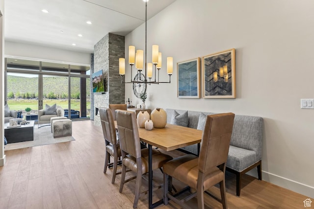 6312 Double Deer Loop, Park City, UT 84098 - dining space with wood finished floors, a chandelier, a towering ceiling, baseboards, and recessed lighting