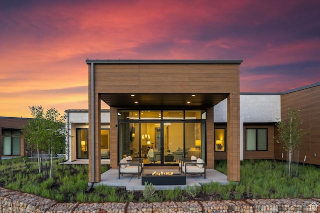 6312 Double Deer Loop, Park City, UT 84098 - back of house at dusk with a patio and an outdoor living space with a fire pit