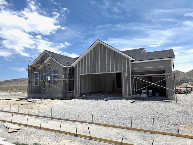 4984 N Topaz Dr Unit 321, Eagle Mountain, UT 84005 - view of front of home with an attached garage, board and batten siding, and a shingled roof