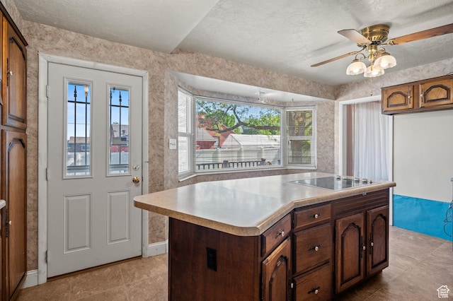 95 E 1400 S, Bountiful, UT 84010 - kitchen featuring black electric stovetop, light countertops, a center island, ceiling fan, and light tile patterned floors