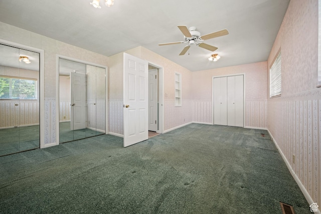 95 E 1400 S, Bountiful, UT 84010 - unfurnished bedroom with carpet floors, multiple closets, wainscoting, and a ceiling fan