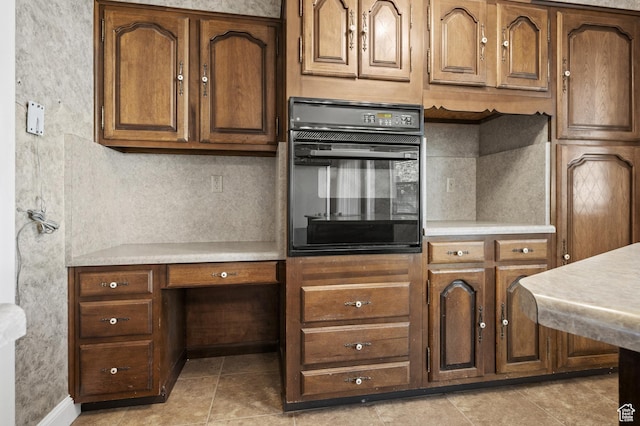 95 E 1400 S, Bountiful, UT 84010 - kitchen featuring oven, light countertops, light tile patterned floors, and brown cabinets