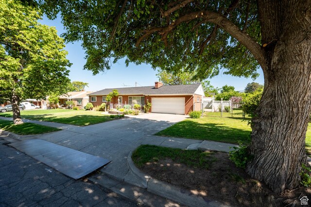 95 E 1400 S, Bountiful, UT 84010 - ranch-style home with a garage, concrete driveway, brick siding, and a chimney