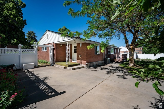 95 E 1400 S, Bountiful, UT 84010 - view of front of home with brick siding, a patio, and central AC unit