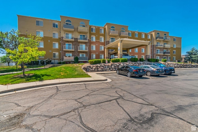 3478 S Cozy River Pl W Unit 210, West Valley City, UT 84119 - view of apartment building / complex with uncovered parking