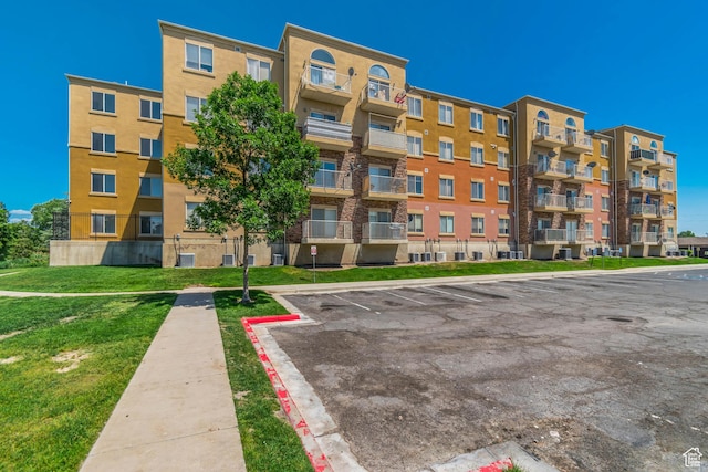 3478 S Cozy River Pl W Unit 210, West Valley City, UT 84119 - view of apartment building / complex with uncovered parking